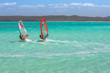 Couple of windsurfers in the vastness of the lagoonの写真素材