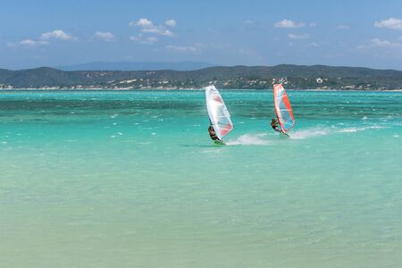 Couple of windsurfers in the vastness of the lagoonの写真素材