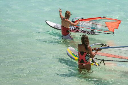 Couple of windsurfers preparing their itineraryの写真素材