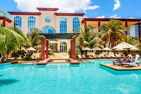 Two girls sunbathing in the luxyry hotel poolの写真素材