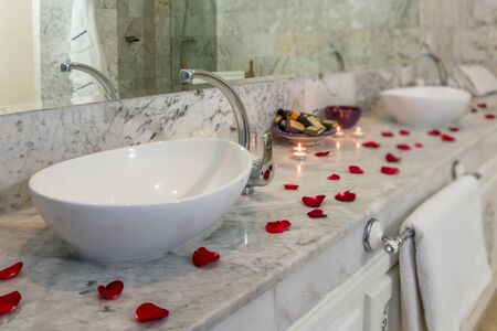 Luxury bathroom with petals and candles decorationの写真素材