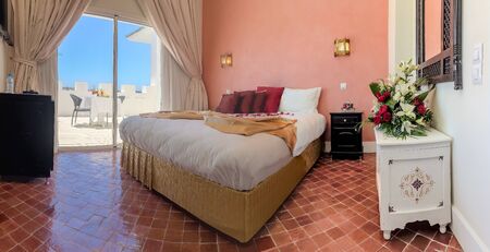 Luxury hotel room in Moroccan style with breakfast on terraceの写真素材