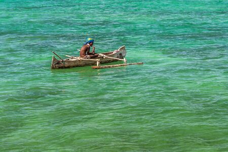 Malagasy fisherman in his outrigger canoe in the lagoon of Andavadoaka, Southwestern Madagascar on October 25, 2016のeditorial素材