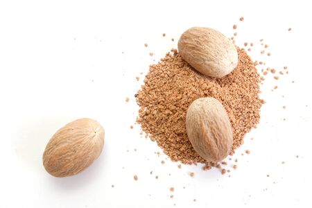 Whole and grated nutmeg isolated on white backgroundの写真素材
