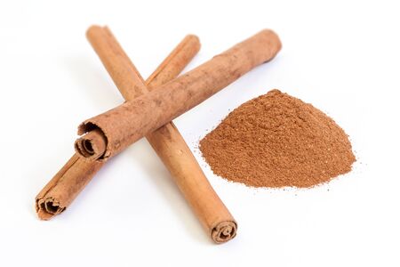 Sticks and powder of cinnamon isolated on white backroundの写真素材