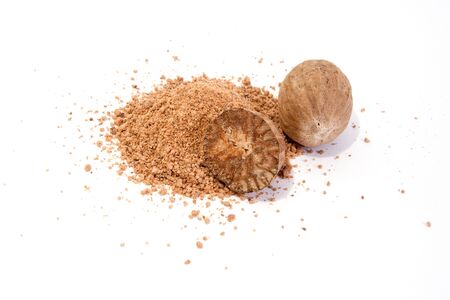 Whole and grated nutmeg isolated on white backgroundの写真素材