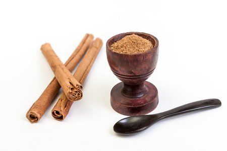 Sticks and powder of cinnamon isolated on white backroundの写真素材