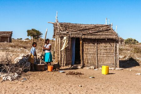 Tsiandamba, Madagascar, july, 21, 2017: Malagasy women using a wooden mortar and pestles in the Vezo village of Tsiandamba, southwestern Madagascar.のeditorial素材