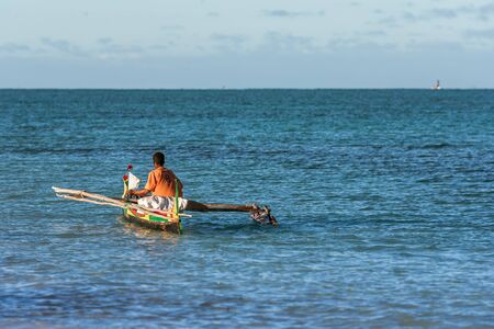 Tsifota, Madagascar, June 06, 2017: Malagasy fisherman rowing his traditional outrigger canoe in the lagoon of southwestern Madagascarのeditorial素材