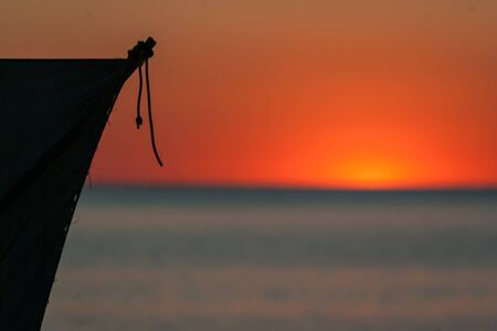 Sail of Malagasy dugout at sunset in southwestern Madagascarの写真素材