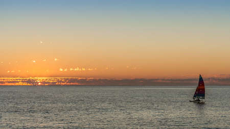 sailing boat at sunset in the lagoonの写真素材