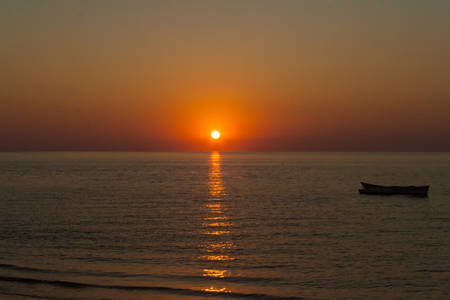 Sunset on an outrigger canoe off Ifaty beach, southwest of Madagascarの写真素材