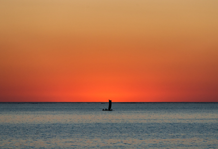 Malagasy fishing sailboat at sunset in southwestern Madagascarの写真素材