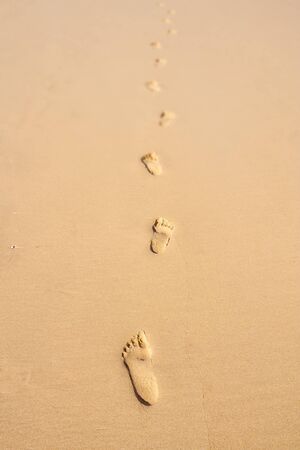Several steps of footprints in the sandの写真素材