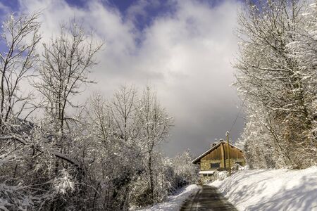 Farm barn in a cold winter landscape with snow and frostの写真素材