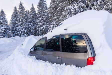 Car almost totally buried under a snow at the alpin ski stationの写真素材