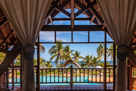 Pool and sea view from the bedroom of a luxury tropical hotelの写真素材