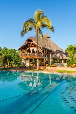 Swimming pool of a luxurious tropical hotel on the seafrontの写真素材