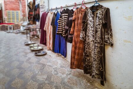 Moroccan clothes for sale at the souk of Asilah, Northern Moroccoの写真素材