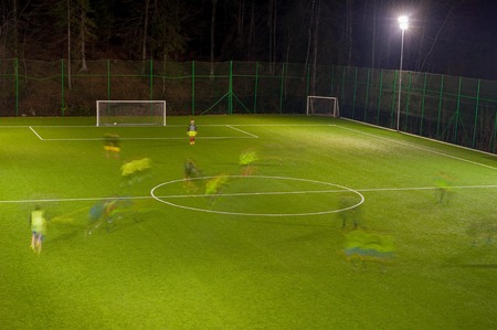 amateur football team training at nightの写真素材