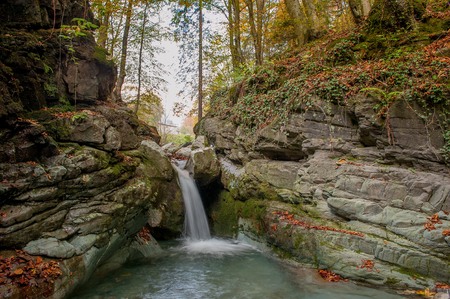 waterfall of river water in the forest in autumnの写真素材