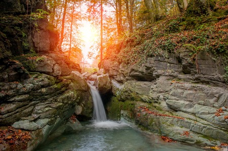 waterfall of river water in the forest in autumnの写真素材