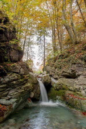 waterfall of river water in the forest in autumnの写真素材