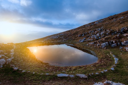 mountain pond to water the livestockの写真素材