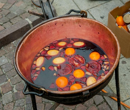copper pot with hot wine and fruitの写真素材