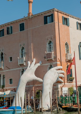 VENICE, ITALY - August 2017: Monumental hands rise from the water in Venice to highlight climate changeのeditorial素材