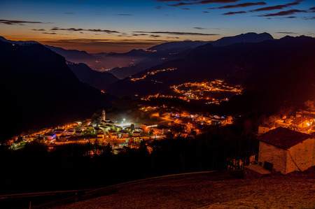 mountain village illuminated at sunsetの写真素材