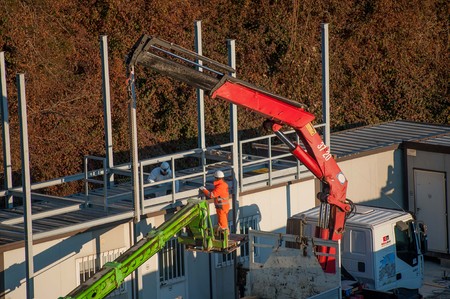 laborer working to raise iron bar