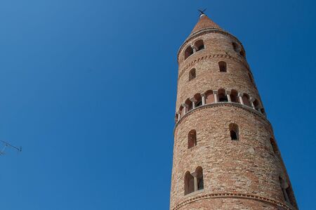 Facade and bell tower of the cathedral of Caorleの写真素材