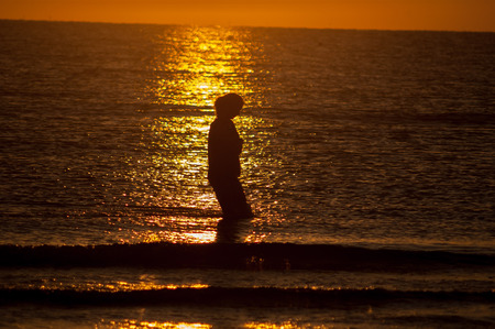girl who walks at sunsetの写真素材