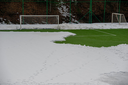 Synthetic soccer field covered with snowの写真素材