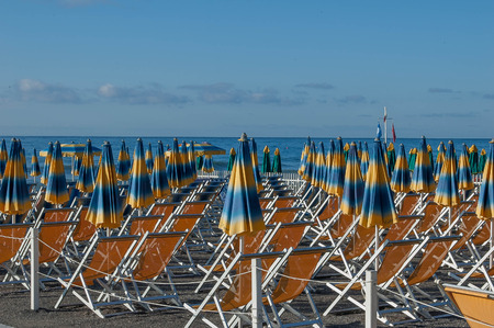 umbrellas ordered in the beach waiting for the swimmersの写真素材