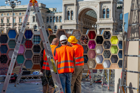 Milan Italy September 26th 2018: workers who dismantle the artistic installation in Piazza Duomo in Milanのeditorial素材