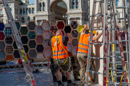 Milan Italy September 26th 2018: workers who dismantle the artistic installation in Piazza Duomo in Milanのeditorial素材