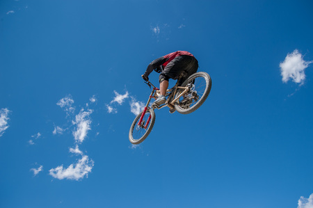 Livigno italy July 27th 2015:boy who finishes the descent by bike with a jumpのeditorial素材
