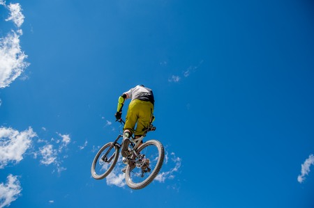 Livigno italy July 27th 2015:boy who finishes the descent by bike with a jumpのeditorial素材