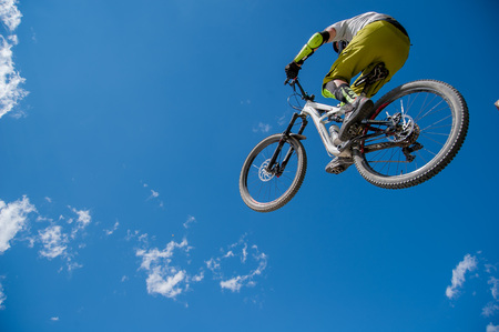 Livigno italy July 27th 2015:boy who finishes the descent by bike with a jumpのeditorial素材