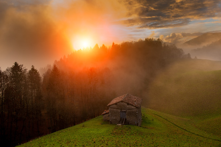 Cottage at sunset with fogのeditorial素材