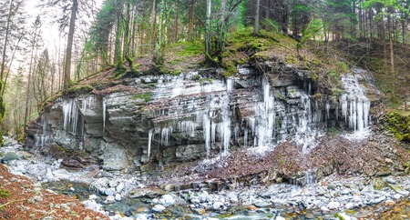 stalactites of ice on steep rockの写真素材