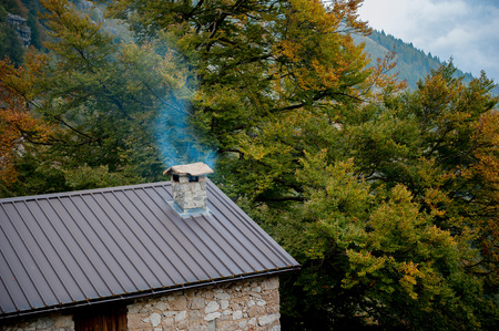 Lost cottage with chimney that smokesの写真素材