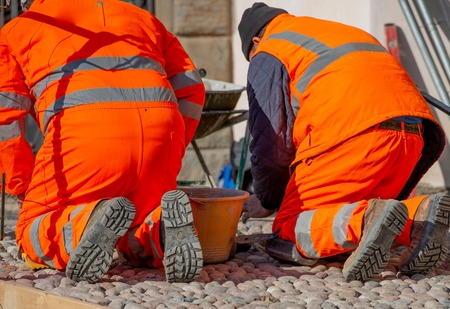 worker laying in pebble floorの写真素材