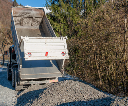 rollover of gravel from trucksの写真素材