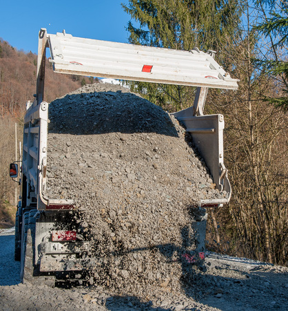 rollover of gravel from trucksの写真素材