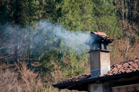 chimney fuming by wood stoveの写真素材
