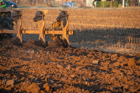 tractor while it is plowing the fieldの写真素材