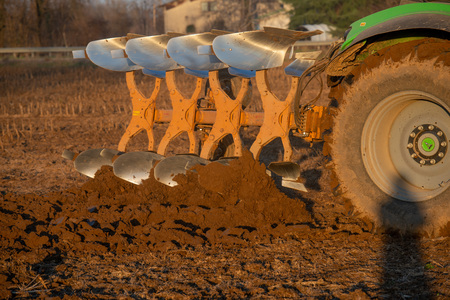tractor while it is plowing the fieldの写真素材